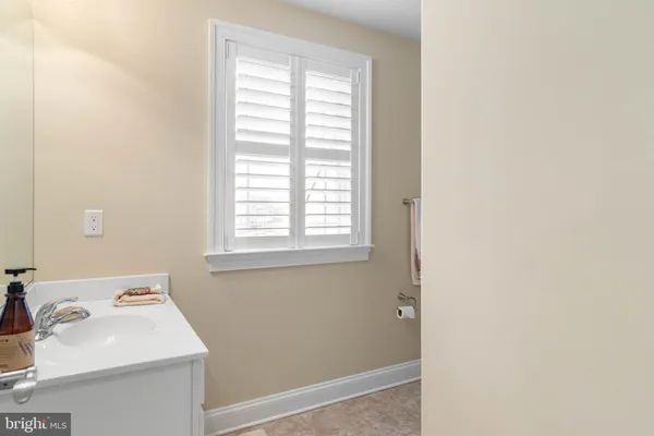 a bathroom with a sink and a window