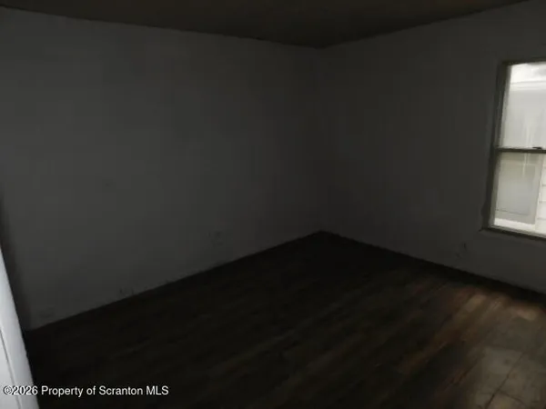 a view of a closet area with wooden floor