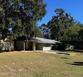 26550 Southwest 4th Road Newberry, FL 32669 - Photo 1 of 1 a front view of a house with a yard