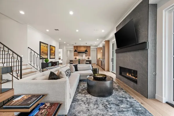 a living room with furniture a flat screen tv and a fireplace