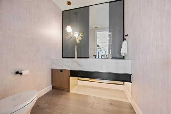 a bathroom with a sink a toilet and mirror