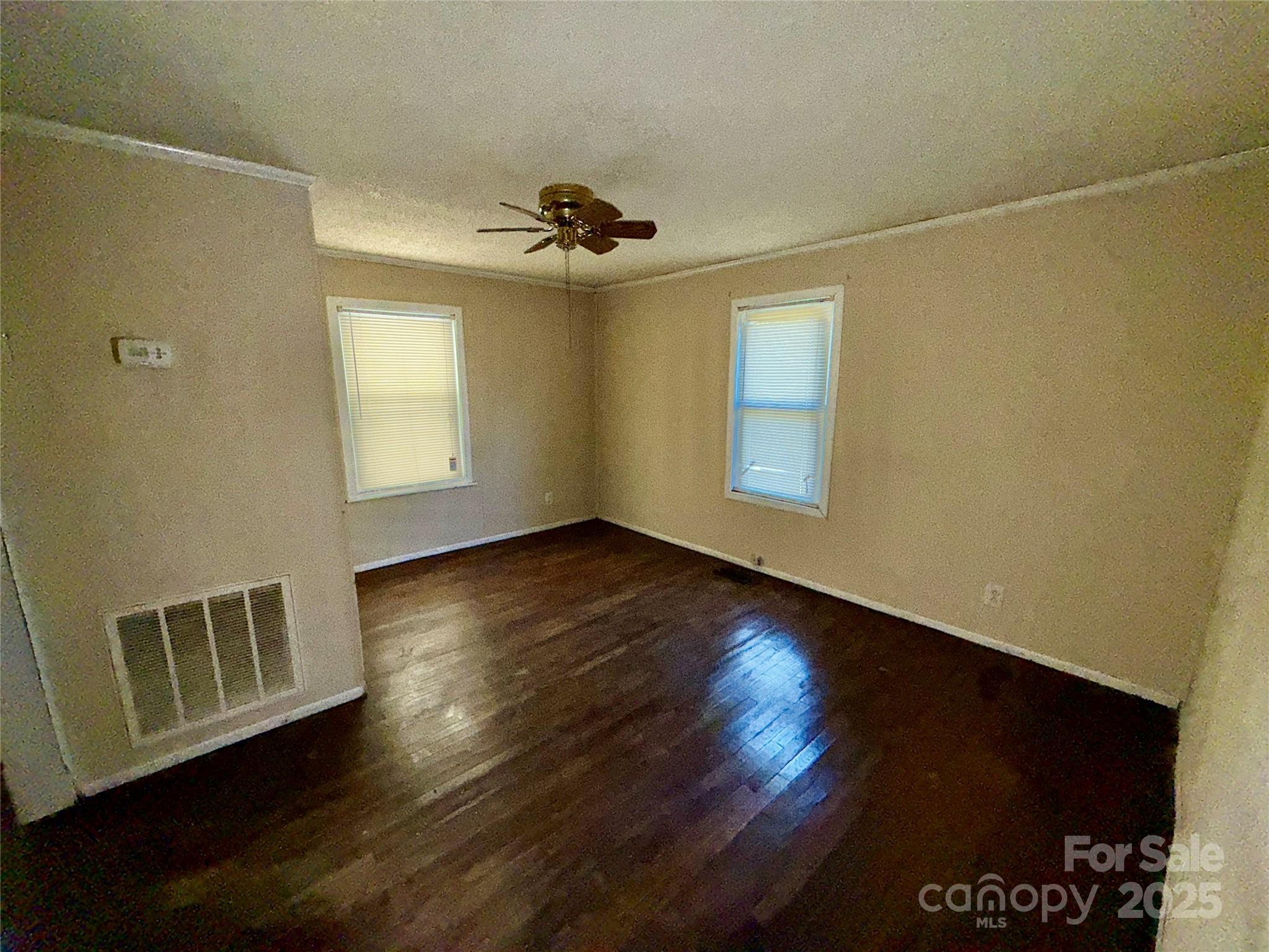 602 Green Chapman Road Gastonia, NC 28056 - Photo 5 of 10 a view of a livingroom with wooden floor and a ceiling fan