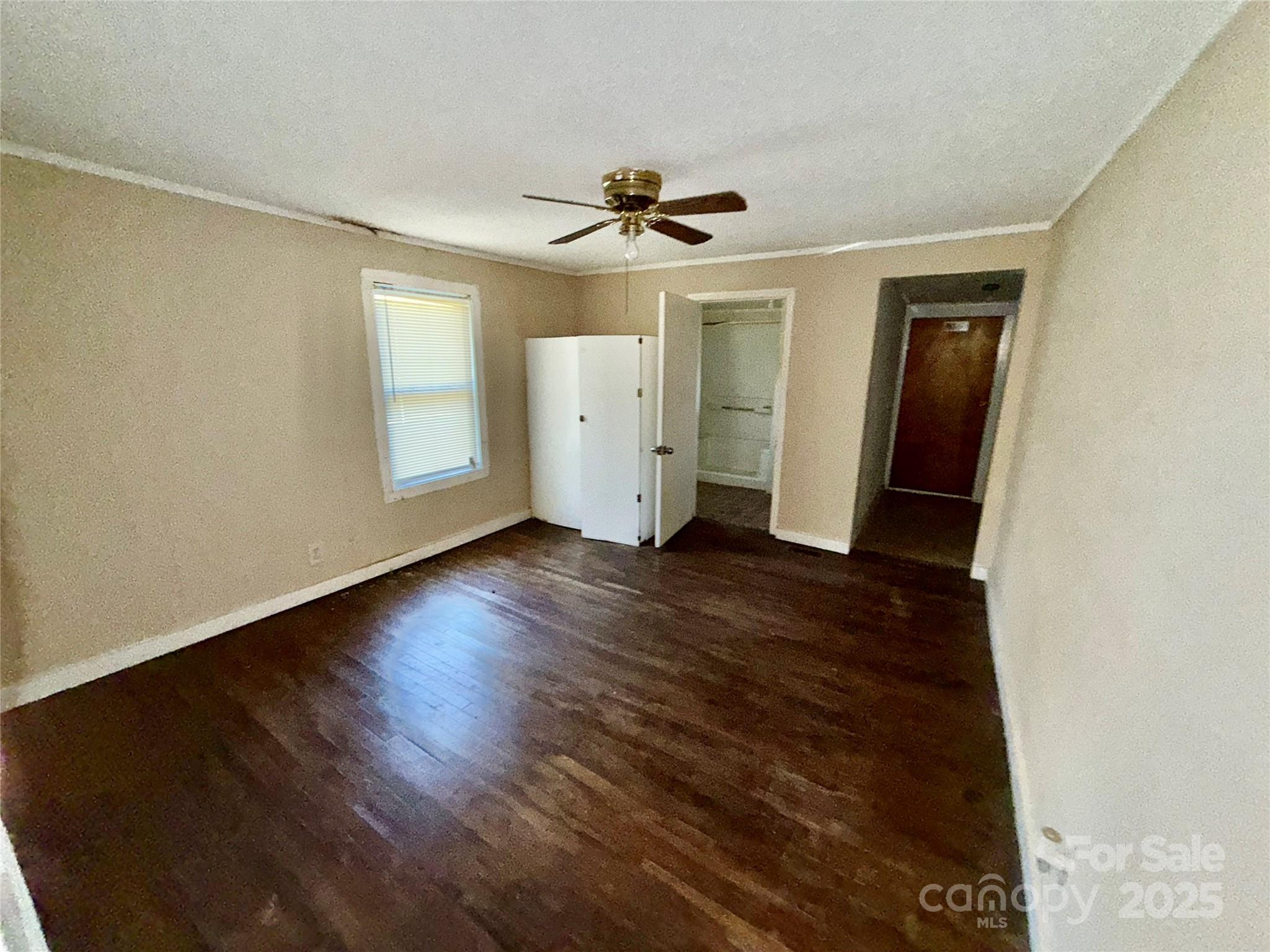 602 Green Chapman Road Gastonia, NC 28056 - Photo 6 of 10 a view of a livingroom with wooden floor and a ceiling fan