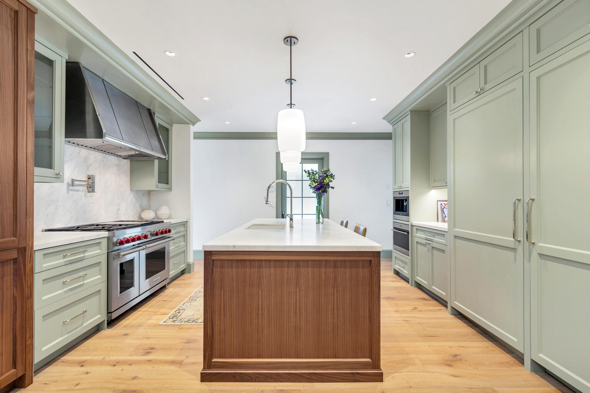 236 Pendleton Avenue Palm Beach, FL 33480 - Photo 11 of 34 a kitchen with kitchen island a counter top space a sink stainless steel appliances and cabinets
