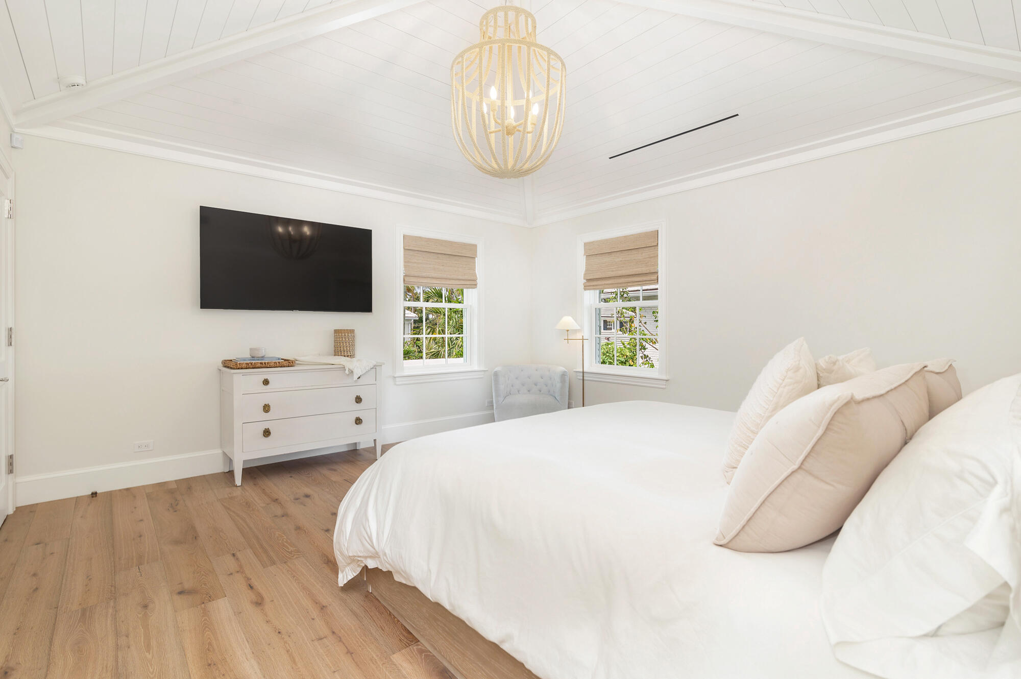 236 Pendleton Avenue Palm Beach, FL 33480 - Photo 17 of 34 a bedroom with a bed and a flat screen tv