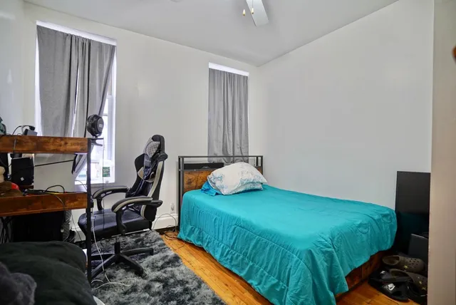 a bedroom with a bed and a window