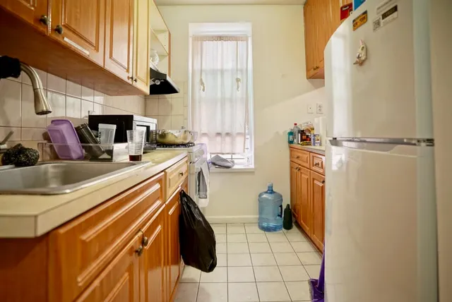 a kitchen with a sink appliances and cabinets