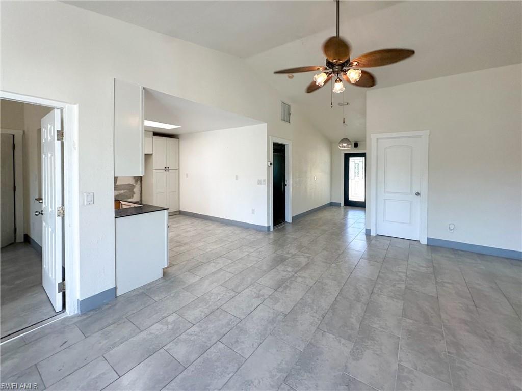 137 Meta Street Fort Myers, FL 33905 - Photo 11 of 50 Unfurnished living room with ceiling fan and high vaulted ceiling