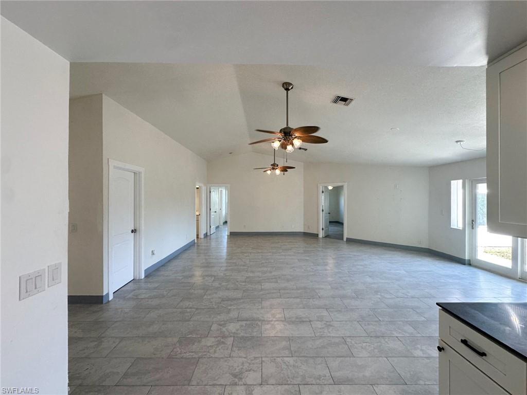 137 Meta Street Fort Myers, FL 33905 - Photo 15 of 50 Unfurnished living room with lofted ceiling and a ceiling fan