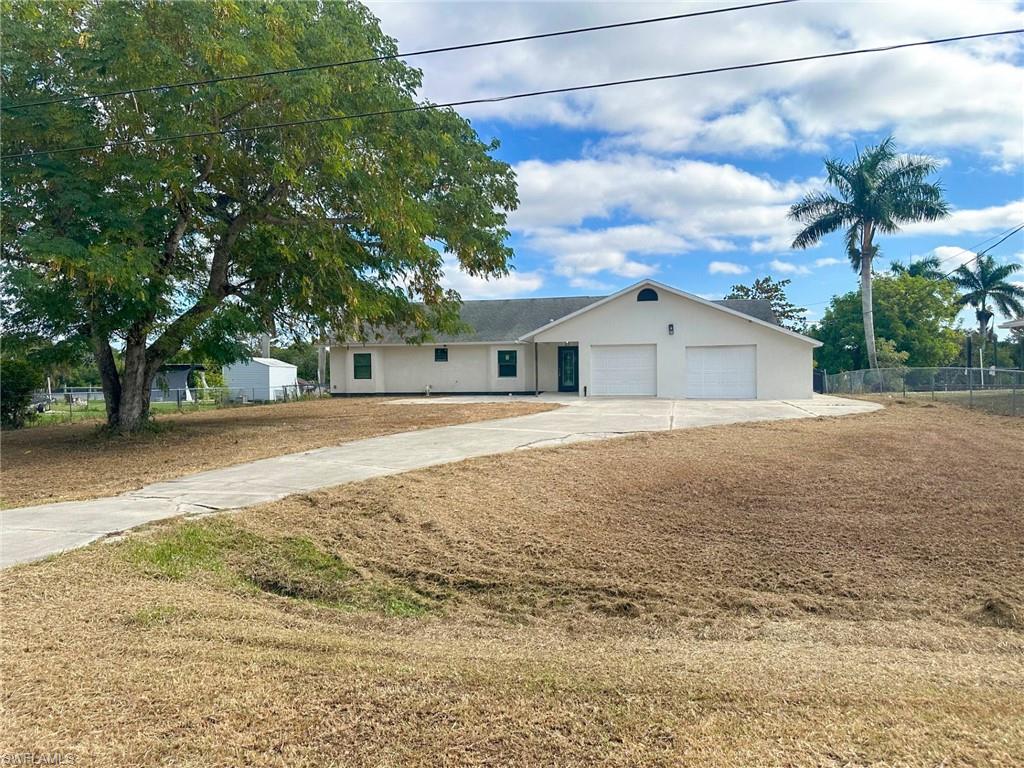 137 Meta Street Fort Myers, FL 33905 - Photo 2 of 50 Ranch-style home featuring concrete driveway, stucco siding, and a garage