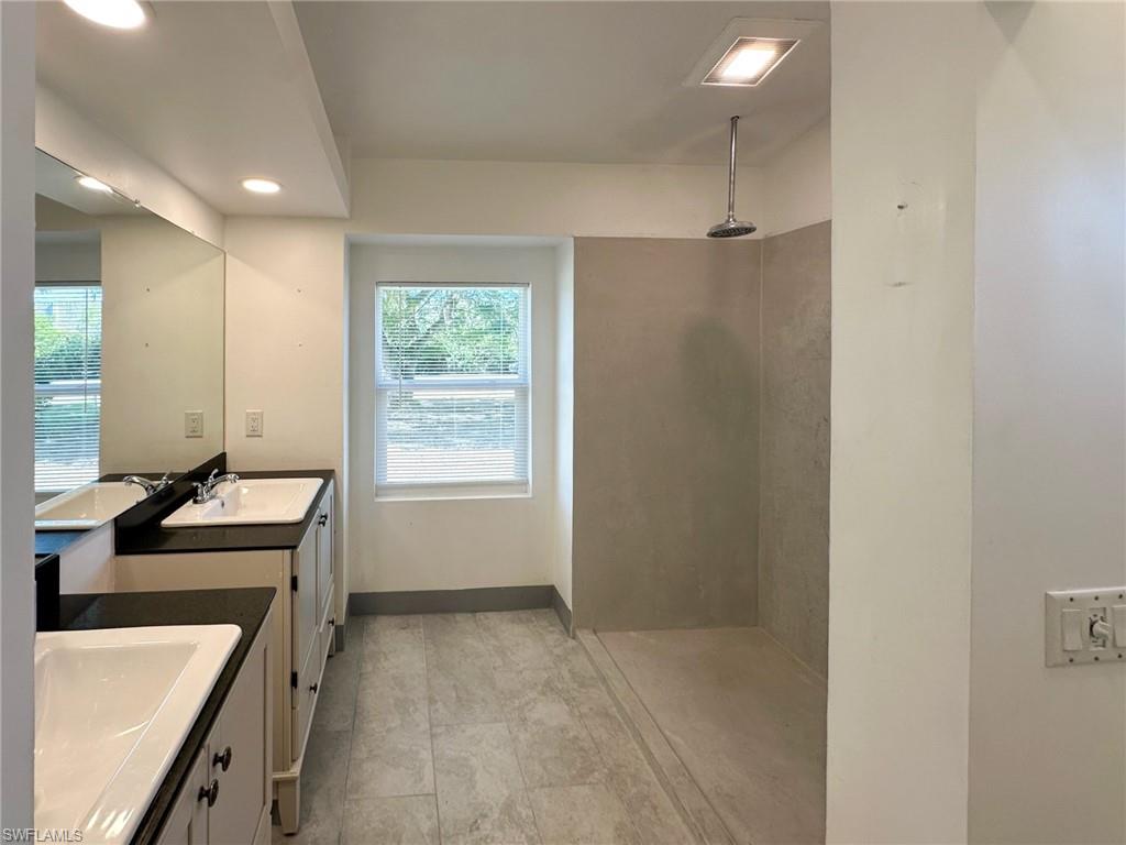 137 Meta Street Fort Myers, FL 33905 - Photo 23 of 50 Full bathroom featuring a walk in shower, two vanities, and recessed lighting