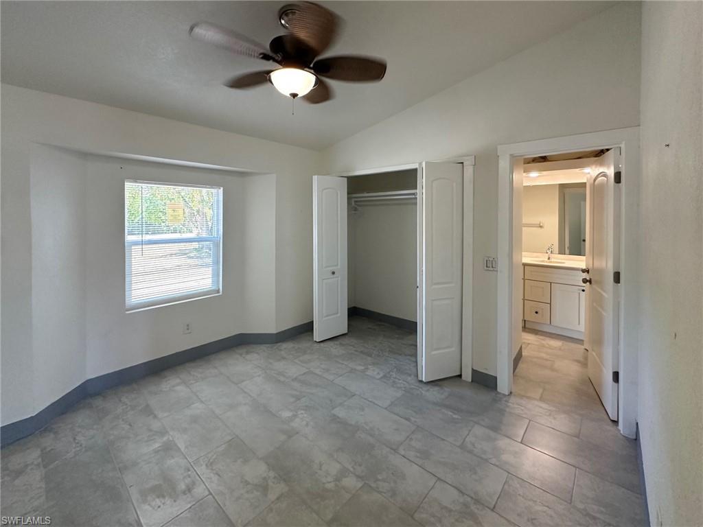 137 Meta Street Fort Myers, FL 33905 - Photo 24 of 50 Unfurnished bedroom with vaulted ceiling, a ceiling fan, and a closet