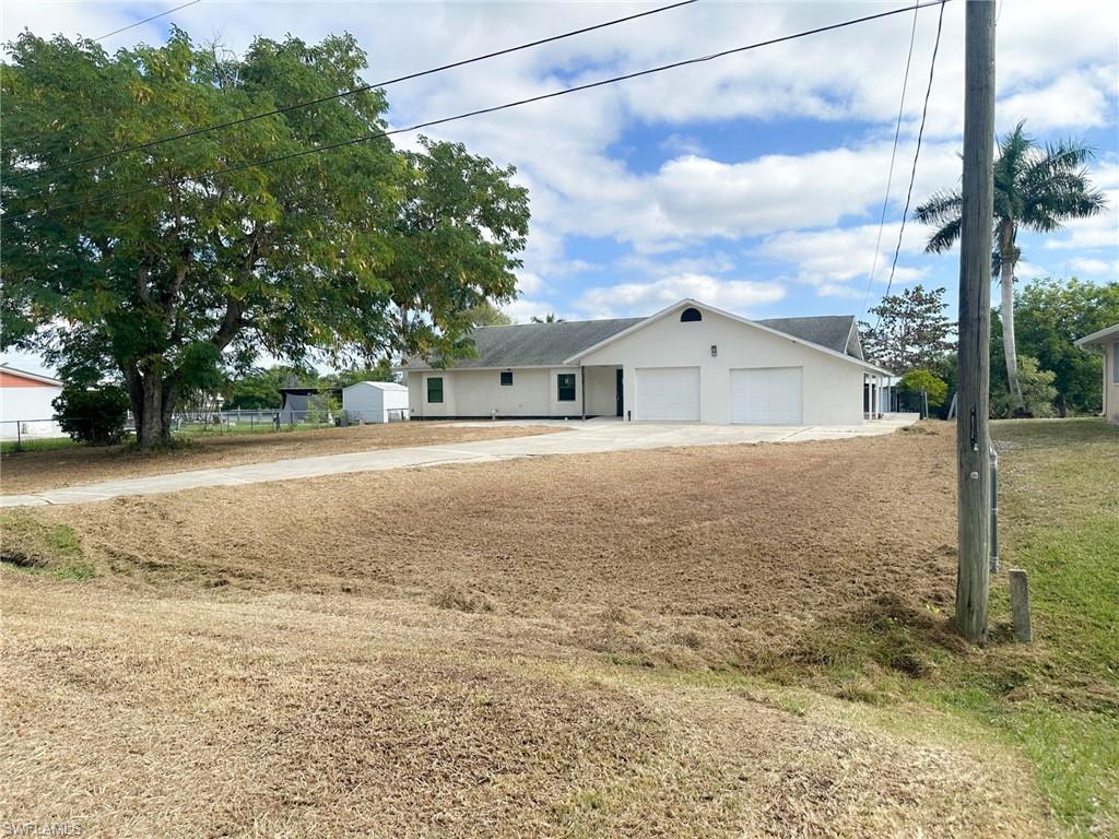 137 Meta Street Fort Myers, FL 33905 - Photo 37 of 50 Ranch-style house with concrete driveway and stucco siding