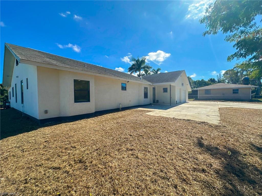 137 Meta Street Fort Myers, FL 33905 - Photo 47 of 50 Back of property with stucco siding and a patio