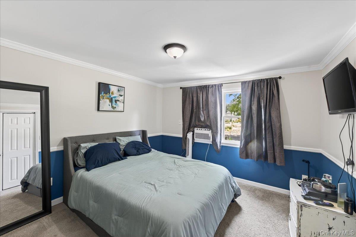 4 Myrtle Lane Coram, NY 11727 - Photo 13 of 20 a bedroom with a bed and a flat screen tv