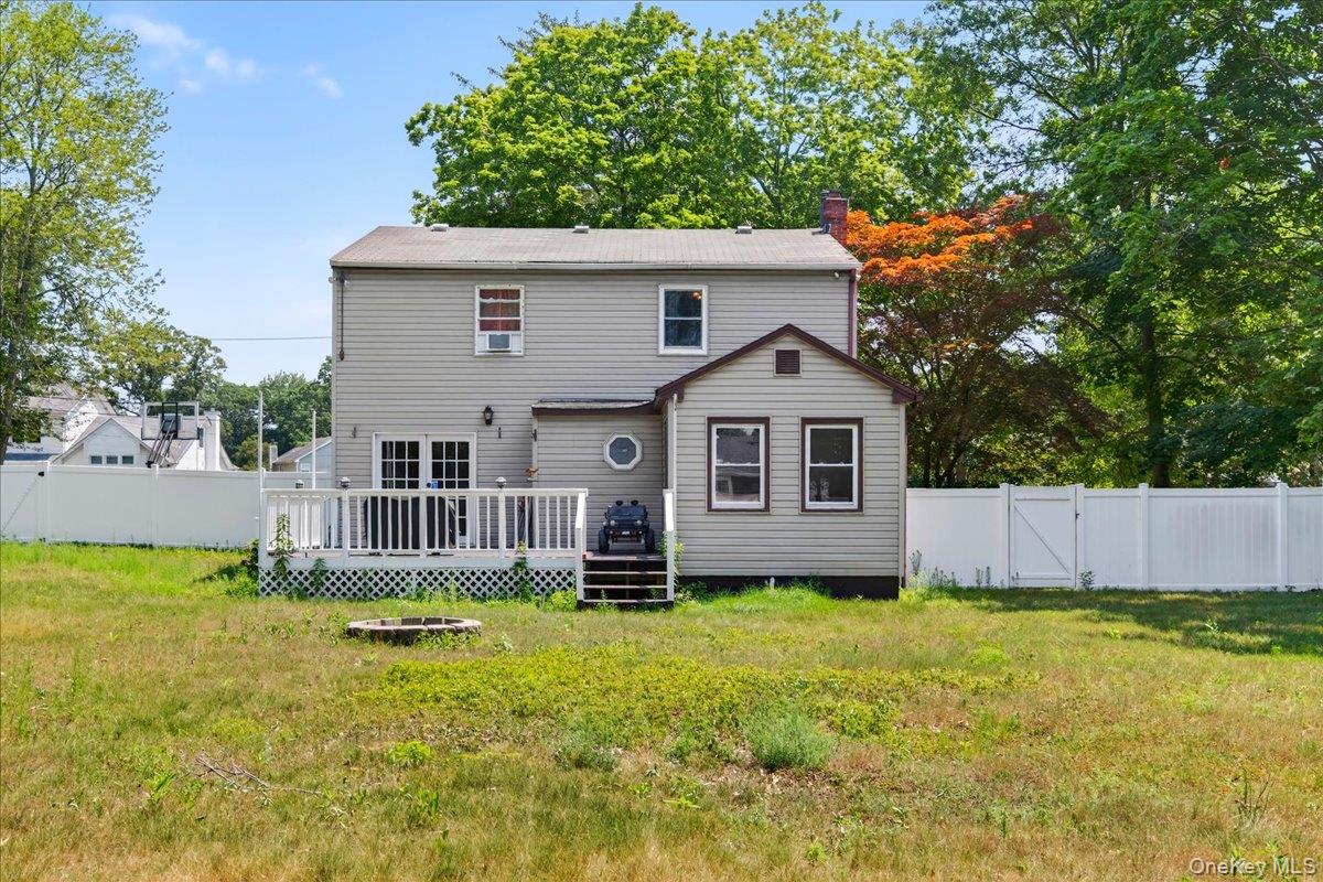 4 Myrtle Lane Coram, NY 11727 - Photo 18 of 20 a front view of house with yard and trees in the background