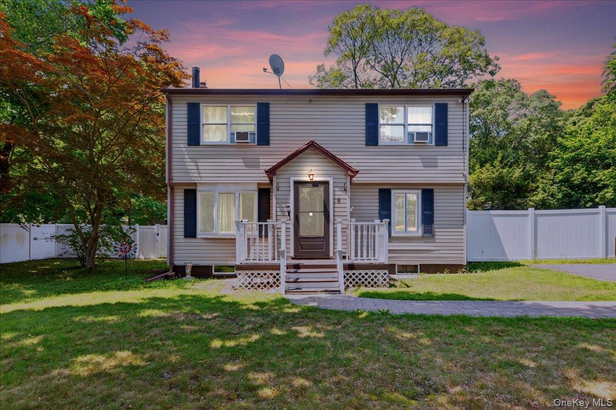 4 Myrtle Lane Coram, NY 11727 - Photo 3 of 20 a front view of a house with a yard