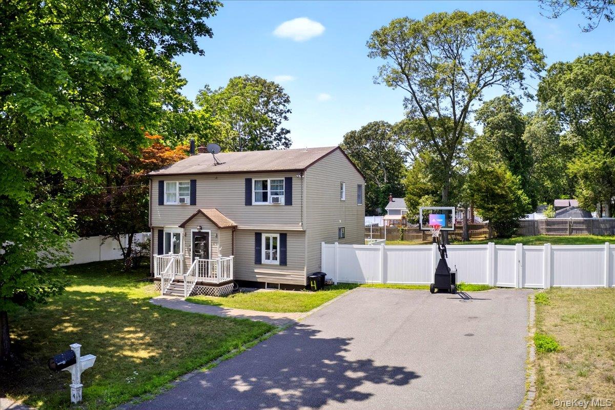 4 Myrtle Lane Coram, NY 11727 - Photo 5 of 20 a front view of a house with a yard patio and swimming pool