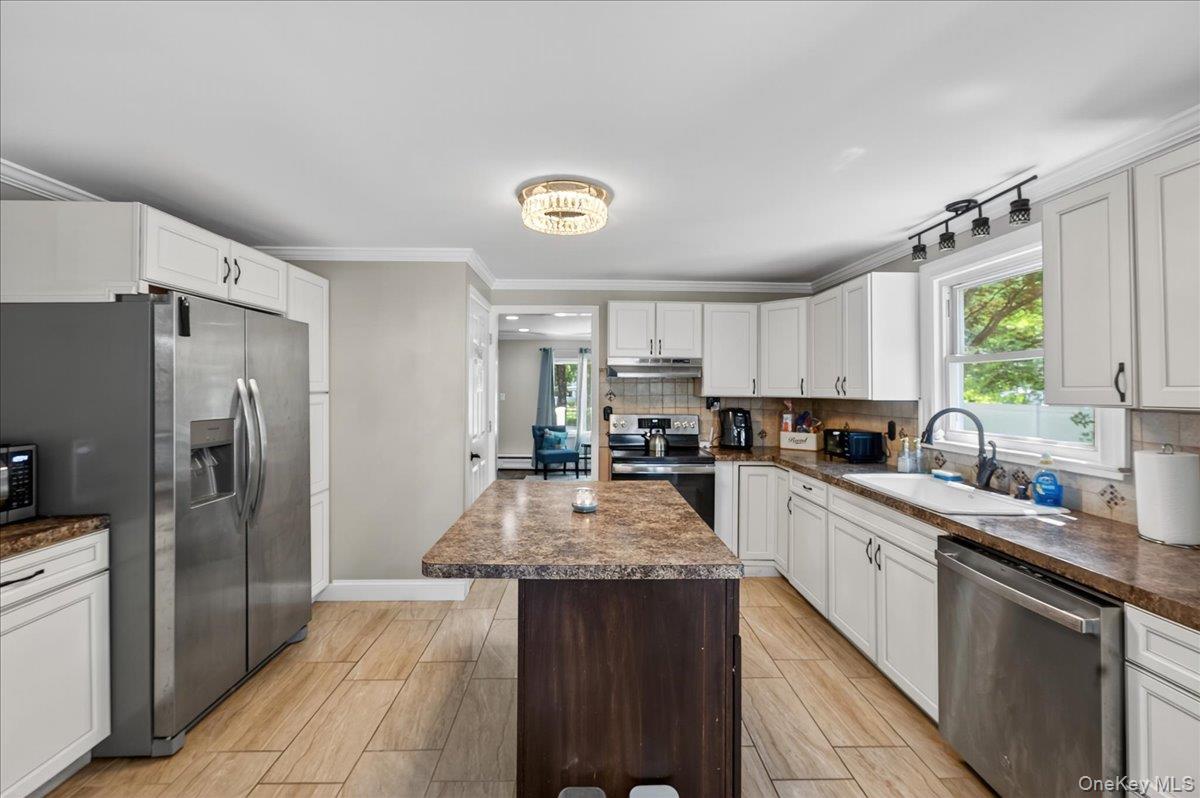 4 Myrtle Lane Coram, NY 11727 - Photo 7 of 20 a kitchen with granite countertop a refrigerator stove and sink