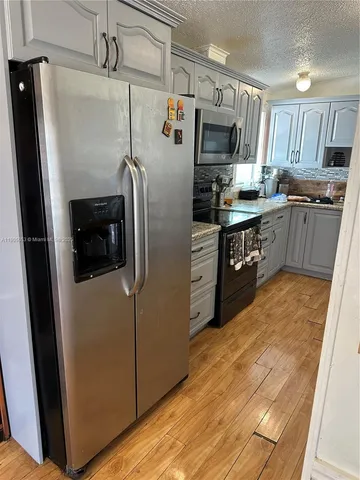 a kitchen with sink a stove and cabinets