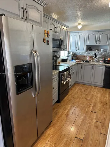 a view of a livingroom with furniture and a flat screen tv