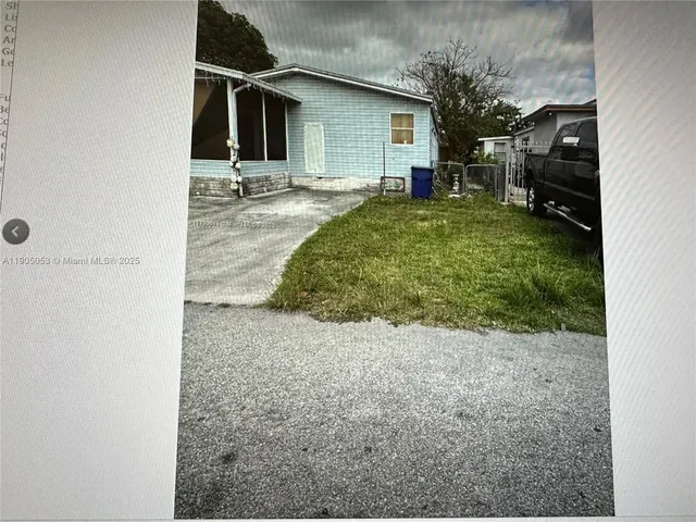 a room with a window and a rug