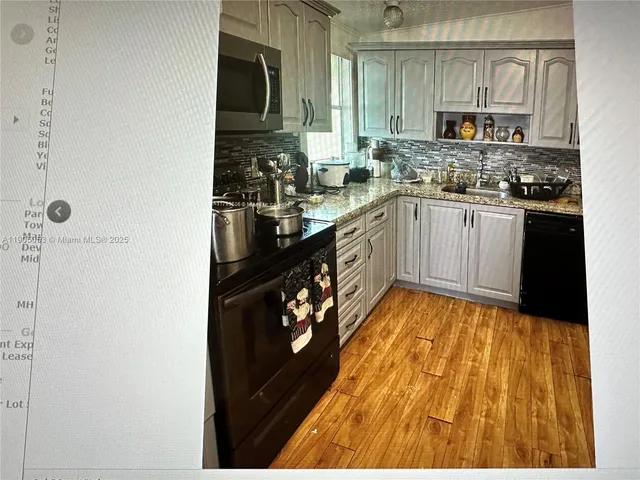 a bedroom with a bed and a flat tv screen on wall