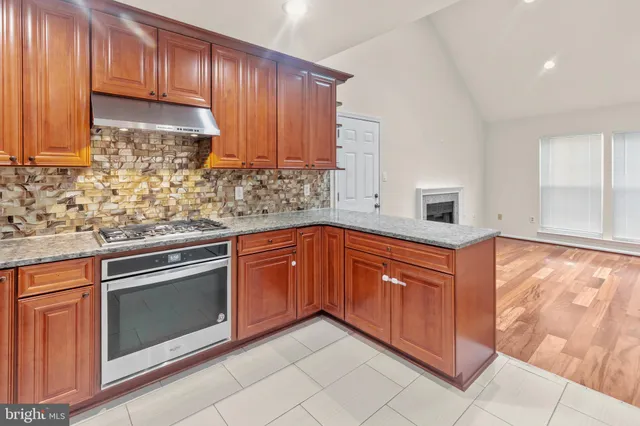 a kitchen with granite countertop cabinets stainless steel appliances and a sink
