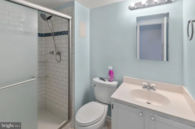a white toilet sitting next to a bathroom sink