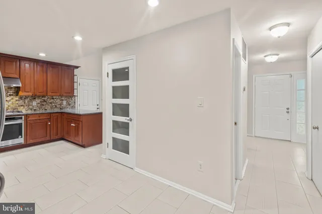 a kitchen with stainless steel appliances a refrigerator and cabinets