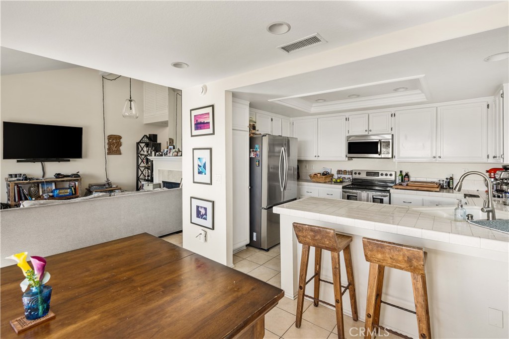 24722 Dana Point Drive Dana Point, CA 92629 - Photo 6 of 17 a kitchen with stainless steel appliances wooden floor and refrigerator
