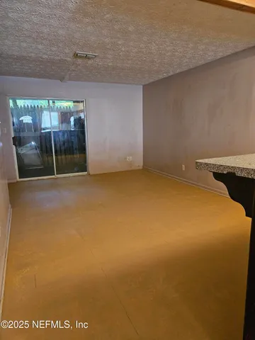 a room with a refrigerator and a more cabinets