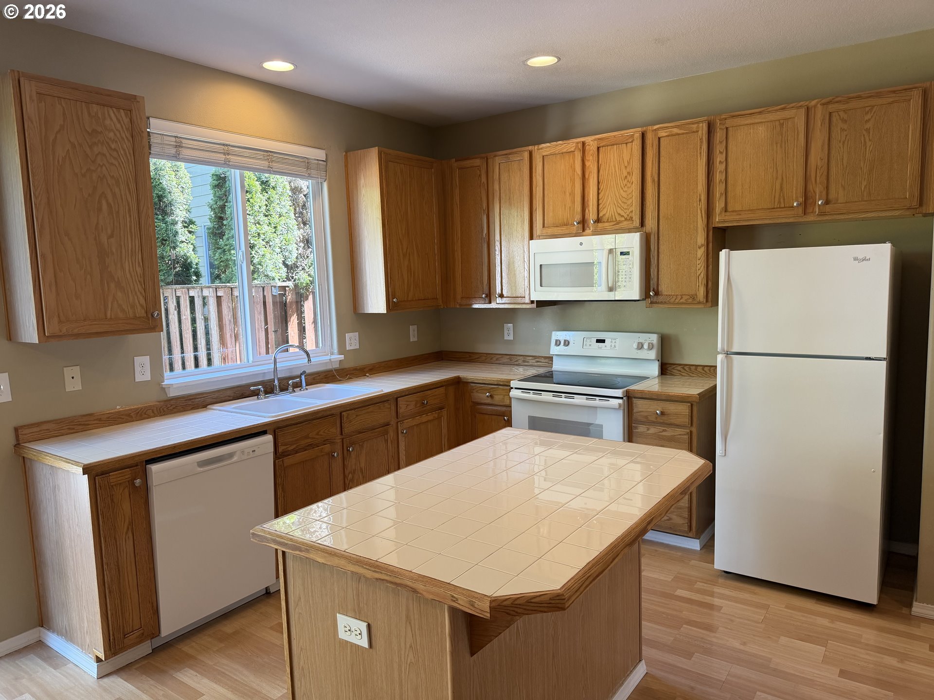 778 Southwest 198th Place Beaverton, OR 97003 - Photo 23 of 24 a kitchen with a refrigerator a stove a sink a center island and a window