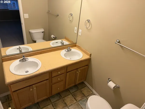 a bathroom with a sink toilet and a mirror