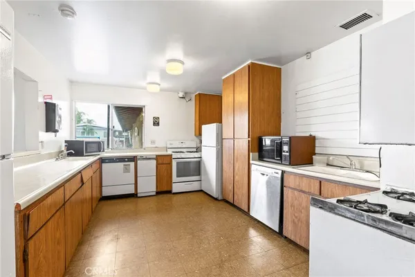 a kitchen with stainless steel appliances a stove sink and refrigerator