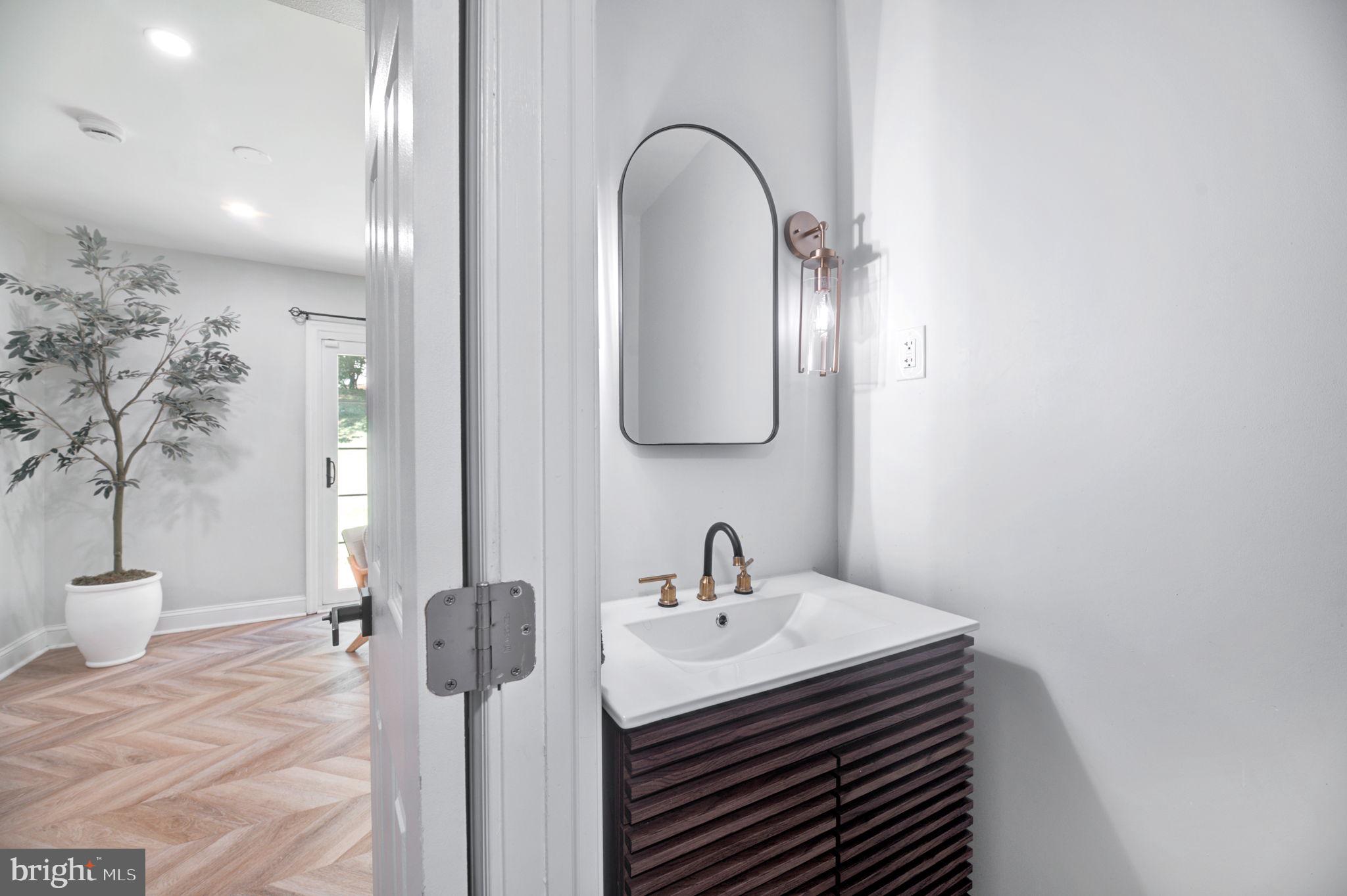 8812 Churchfield Lane Laurel, MD 20708 - Photo 18 of 31 a bathroom with a sink and mirror