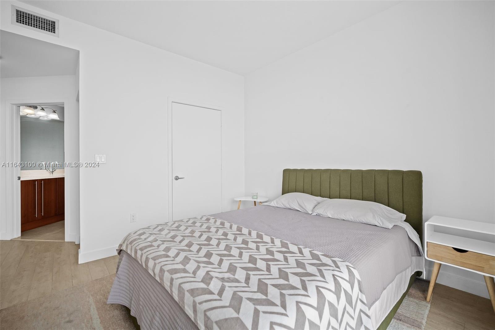 1111 Southwest 1st Avenue, Unit 3425N Miami, FL 33130 - Photo 11 of 35 a large bed sitting in a bedroom next to a bathroom