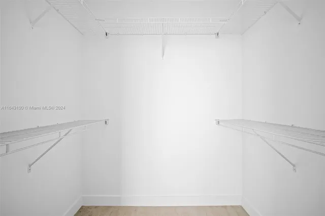 a bathroom with a tub a sink and mirror