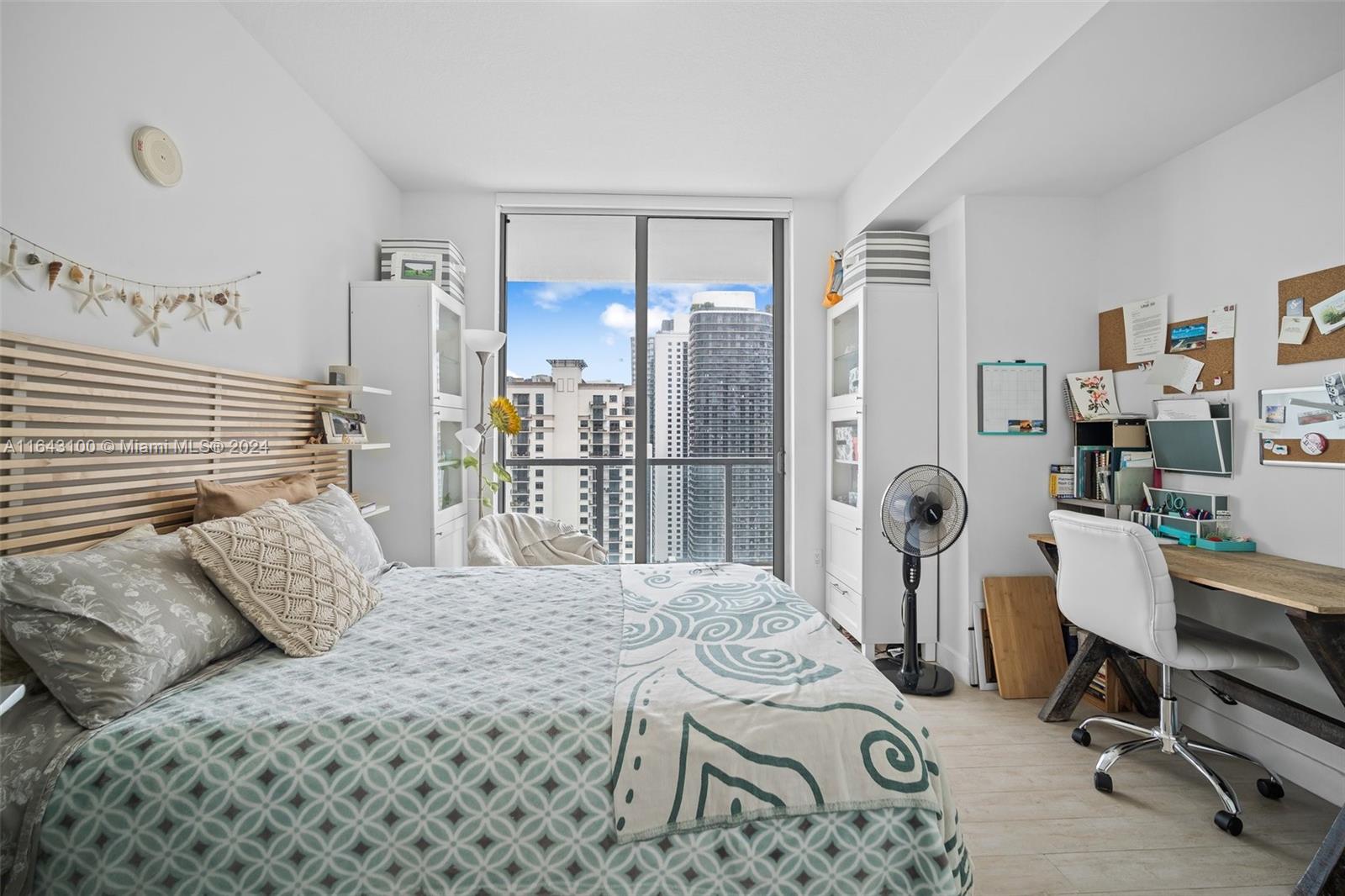 1111 Southwest 1st Avenue, Unit 3425N Miami, FL 33130 - Photo 16 of 35 a bedroom with a bed a table and a large mirror