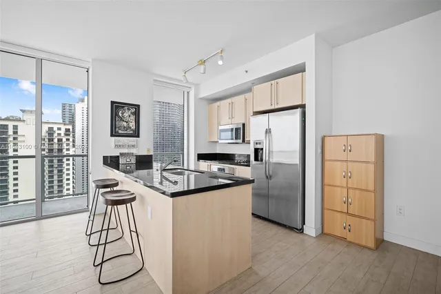 a kitchen with stainless steel appliances a white cabinets and stove top oven