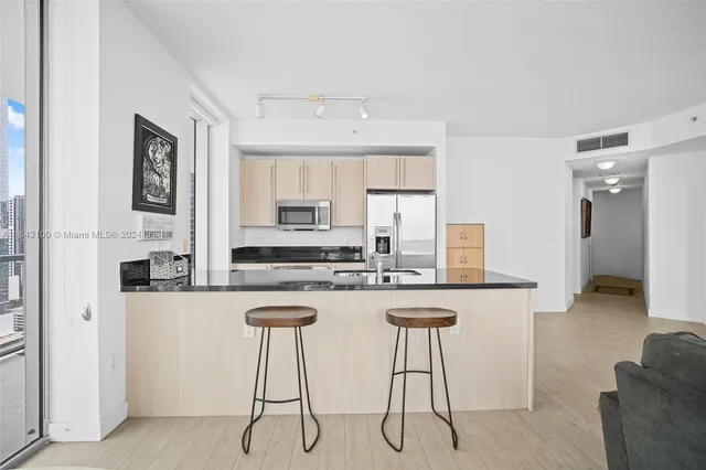 a view of a kitchen with a sink and cabinets