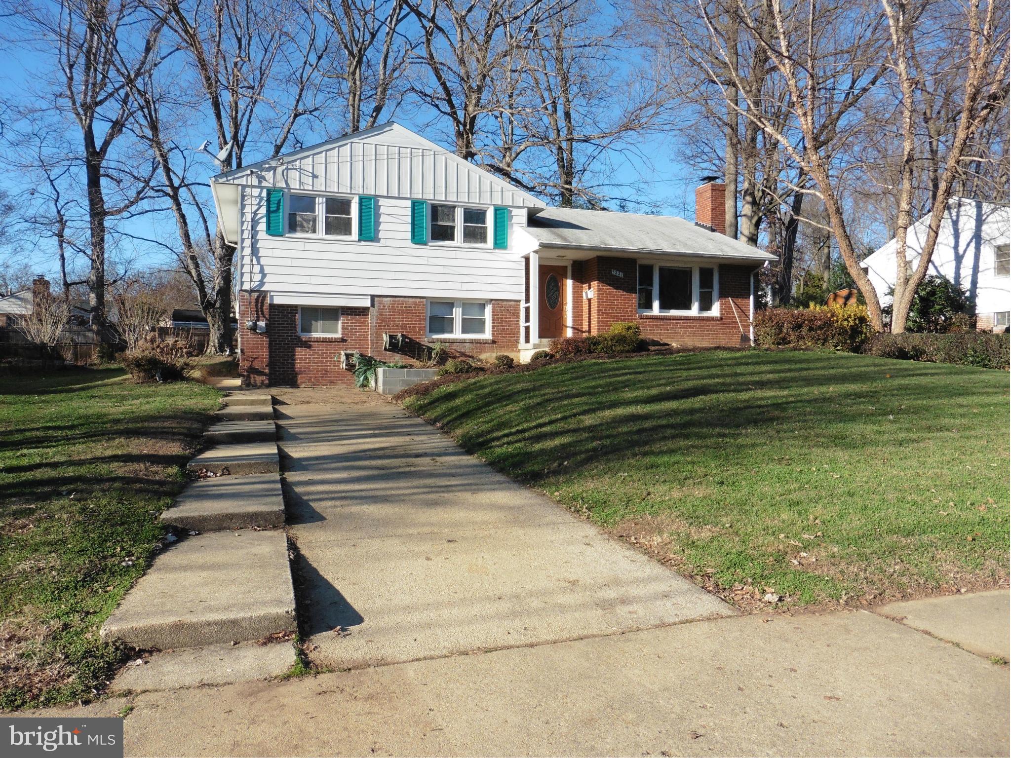 5227 Ravensworth Road Springfield, VA 22151 - Photo 2 of 27 a front view of a house with a yard