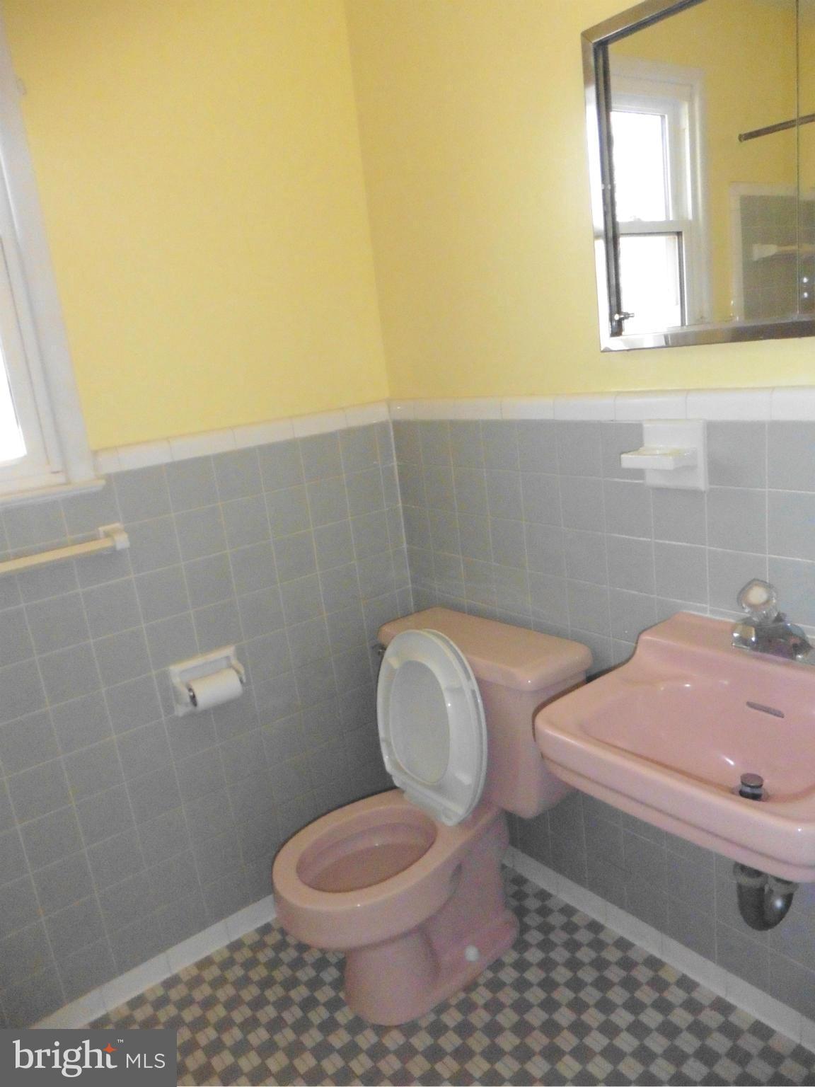 5227 Ravensworth Road Springfield, VA 22151 - Photo 11 of 27 a bathroom with a toilet a sink and a window