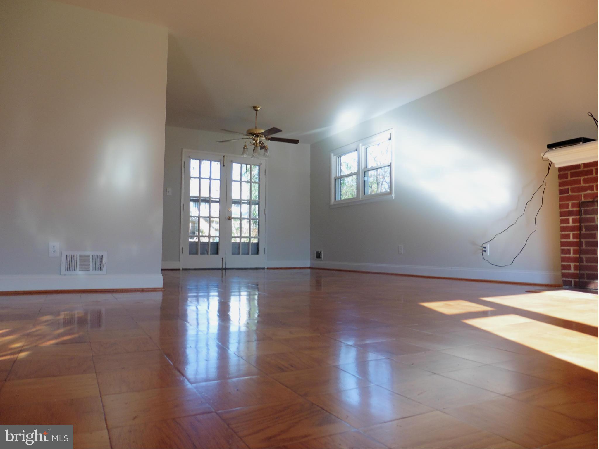 5227 Ravensworth Road Springfield, VA 22151 - Photo 15 of 27 an empty room with wooden floor and windows