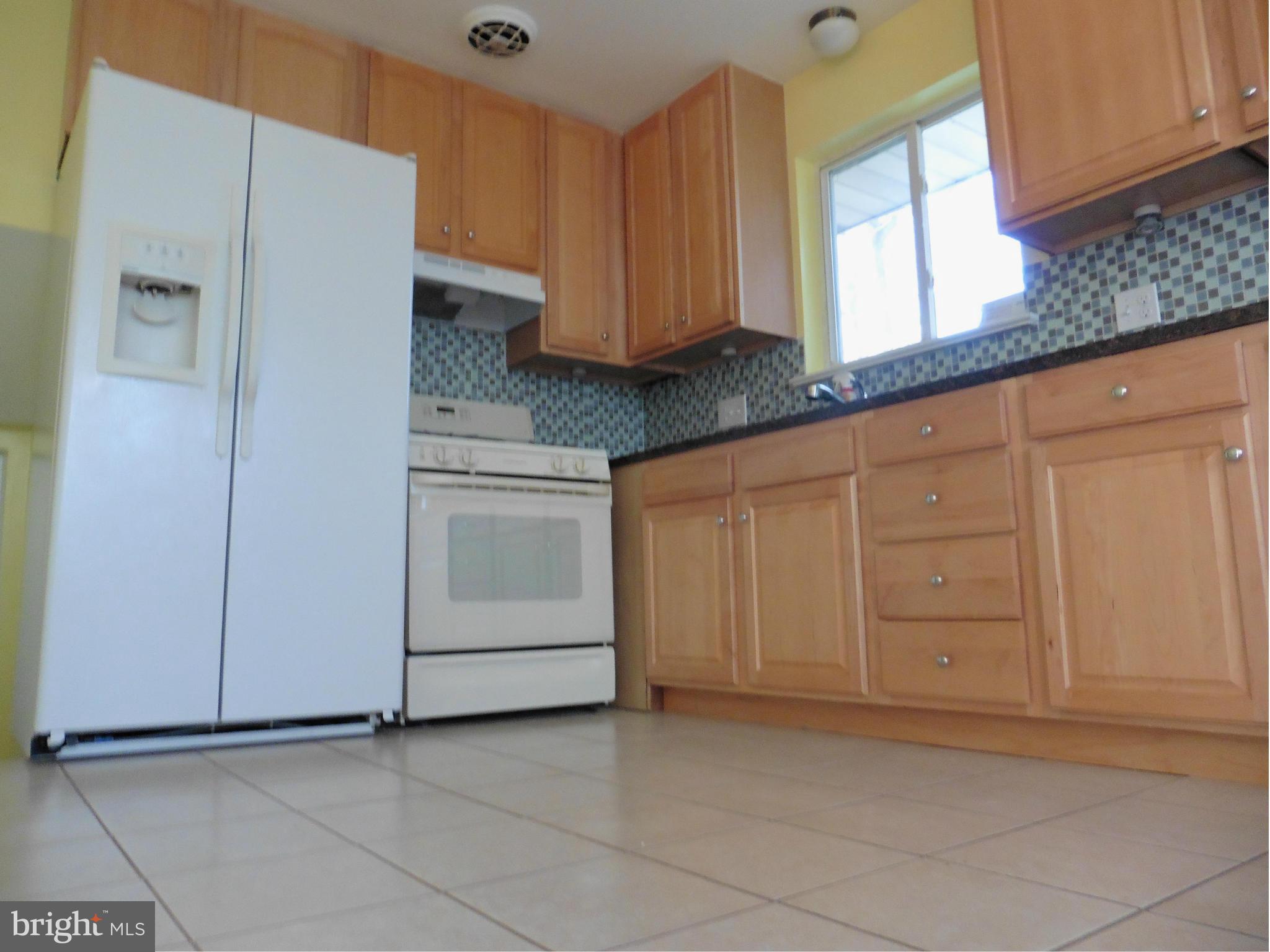 5227 Ravensworth Road Springfield, VA 22151 - Photo 16 of 27 a kitchen with granite countertop white cabinets and stainless steel appliances