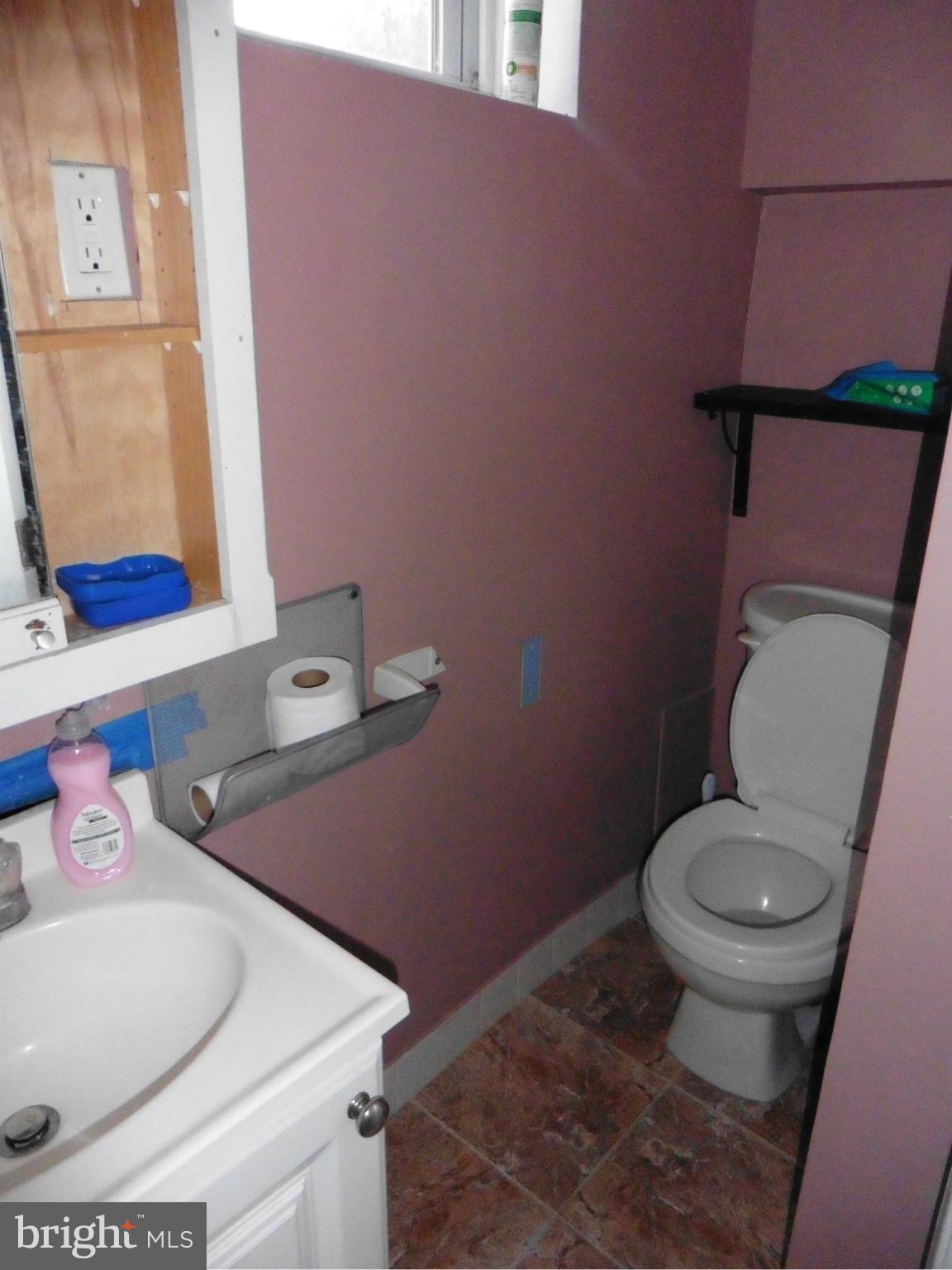 5227 Ravensworth Road Springfield, VA 22151 - Photo 22 of 27 a bathroom with a toilet sink and mirror