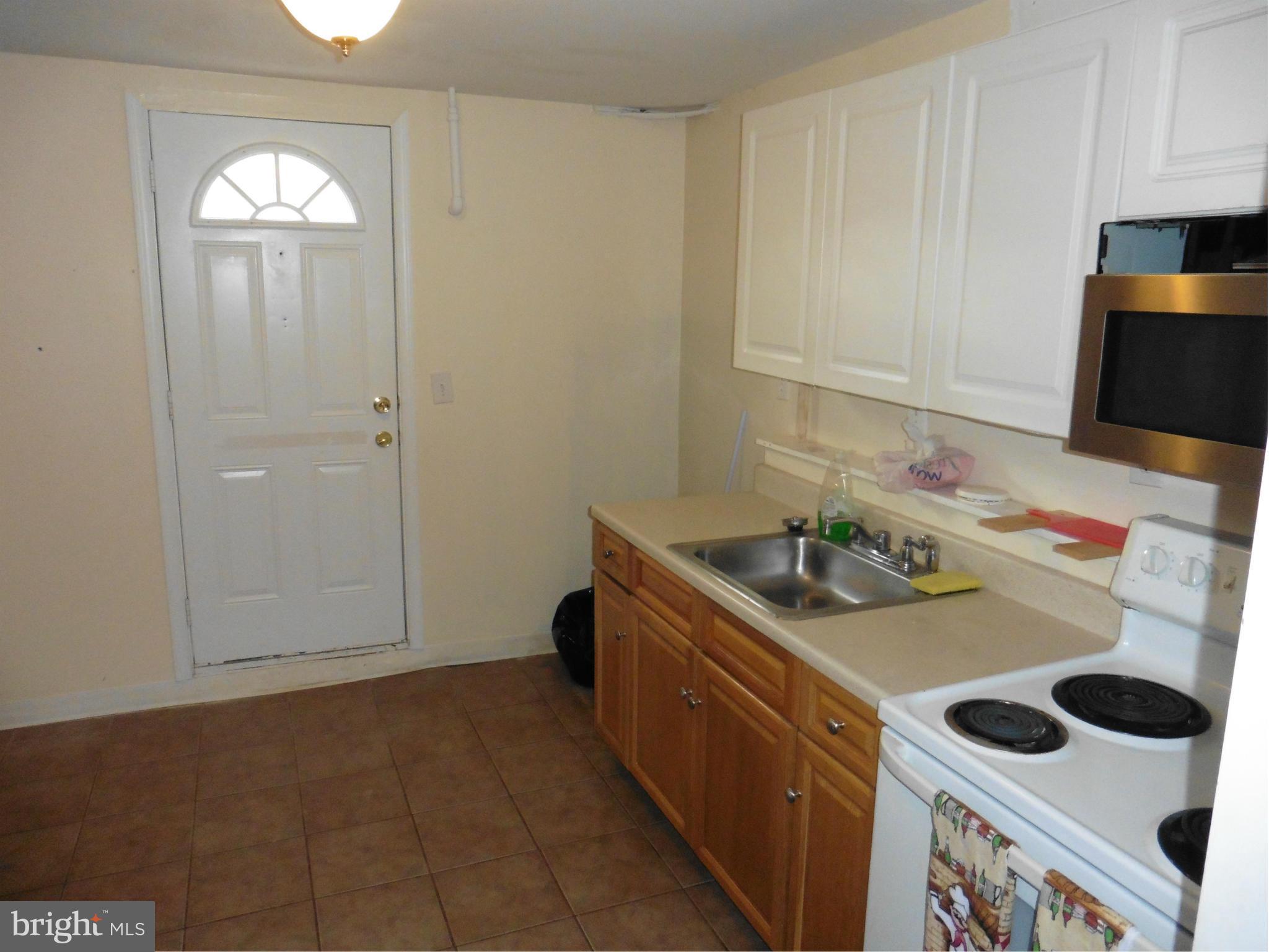 5227 Ravensworth Road Springfield, VA 22151 - Photo 27 of 27 a kitchen with stainless steel appliances granite countertop a sink stove and refrigerator