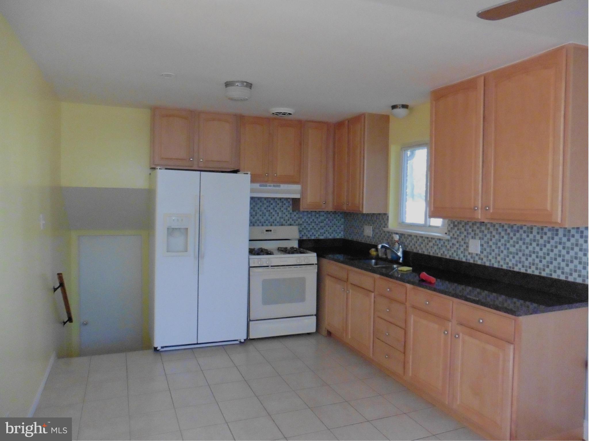 5227 Ravensworth Road Springfield, VA 22151 - Photo 5 of 27 a kitchen with stainless steel appliances granite countertop a stove a sink and a refrigerator