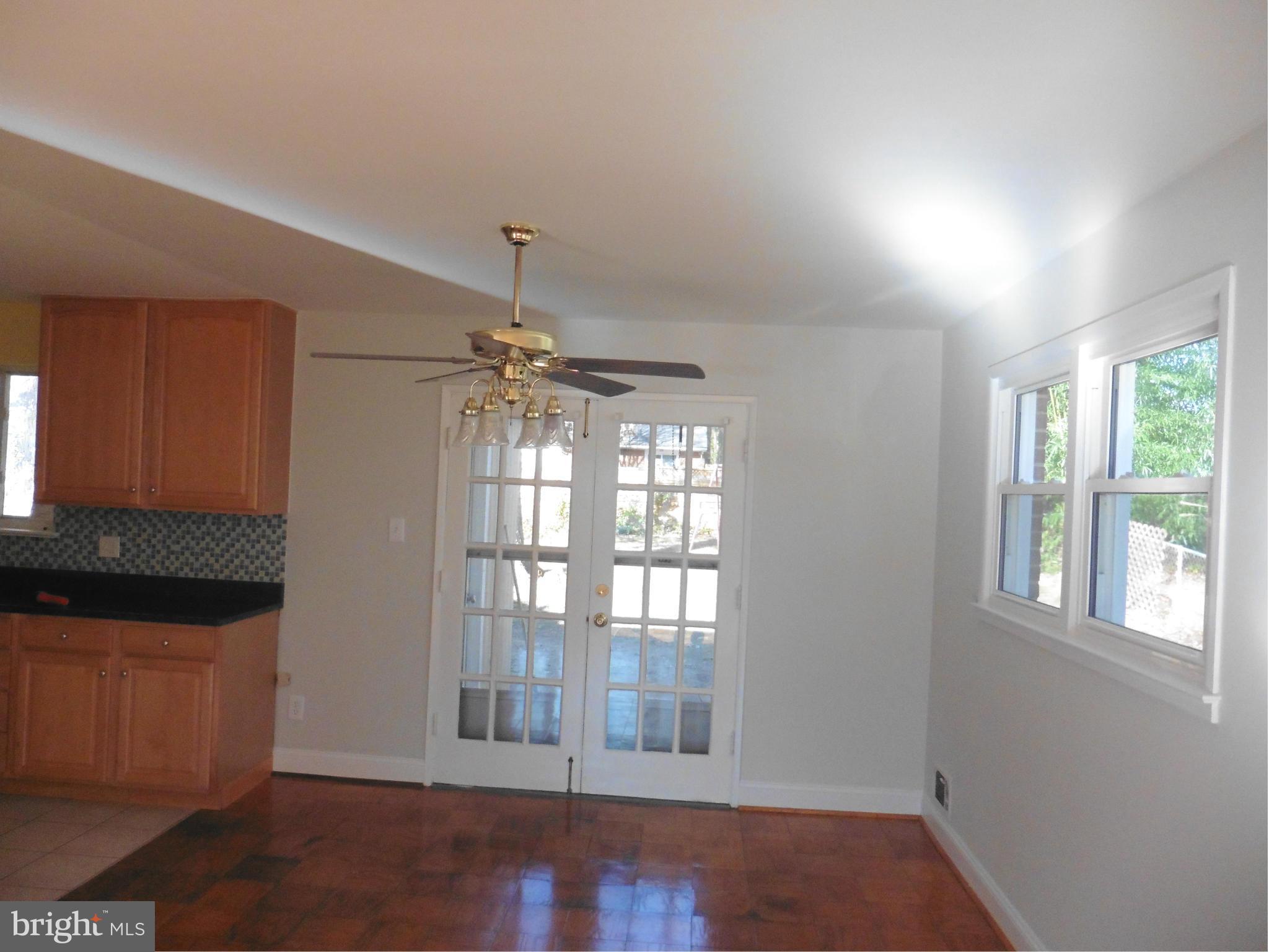 5227 Ravensworth Road Springfield, VA 22151 - Photo 6 of 27 a view of an empty room with wooden floor and a window