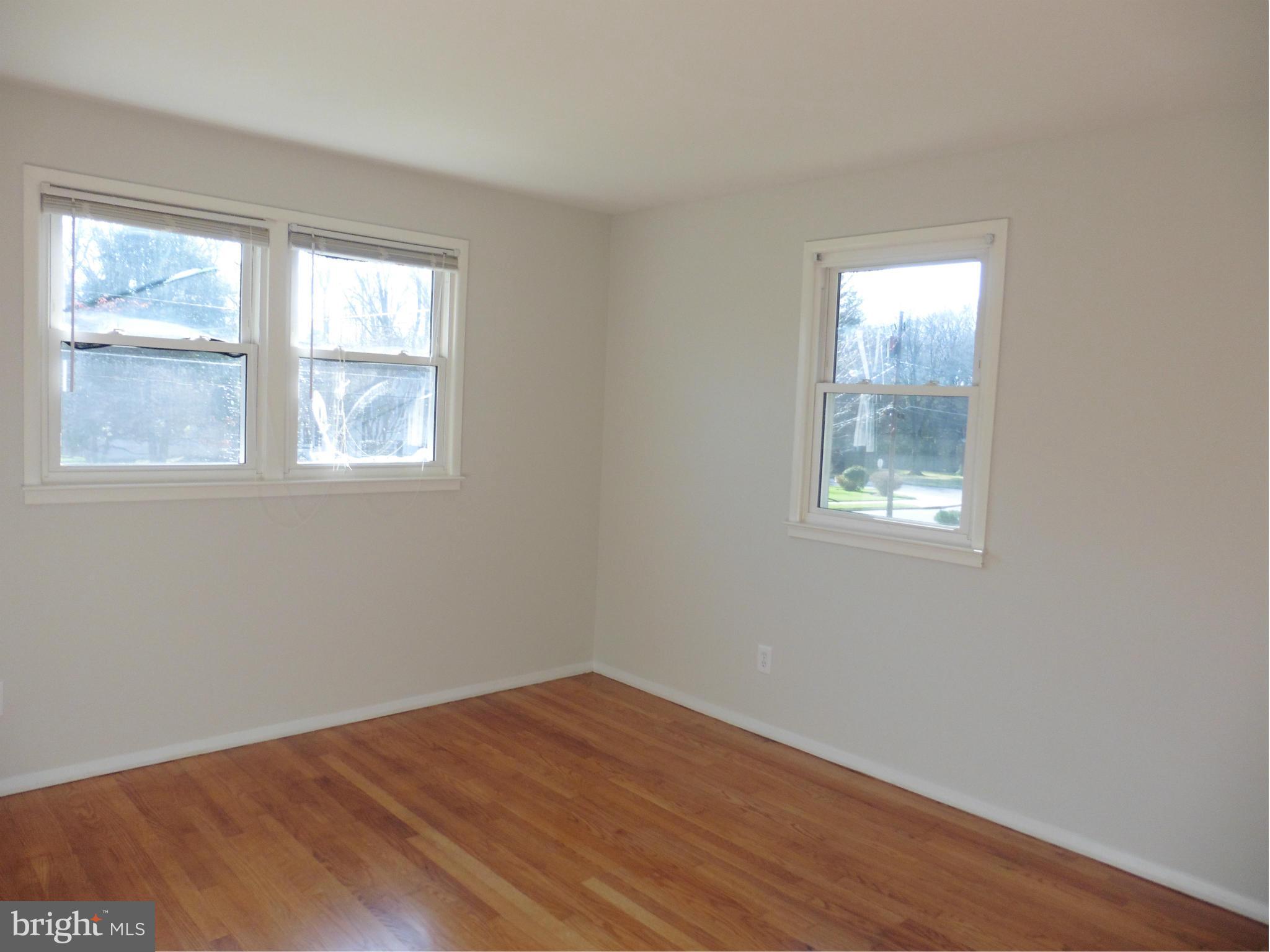 5227 Ravensworth Road Springfield, VA 22151 - Photo 9 of 27 an empty room with wooden floor and windows
